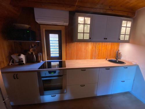 a kitchen with a sink and a counter top at Chata Hugo in Jarabá