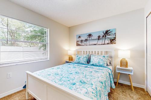 a bedroom with a bed and a window at Poolside Postcards in Kissimmee