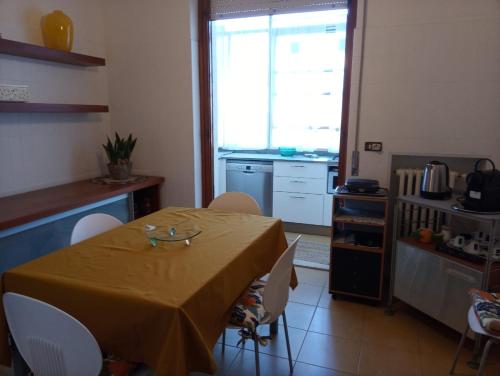 a kitchen with a table and chairs in a kitchen at Angela Home in Rimini