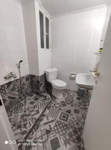 a bathroom with a toilet and a sink at anamnesis Agrinio in Agrinion