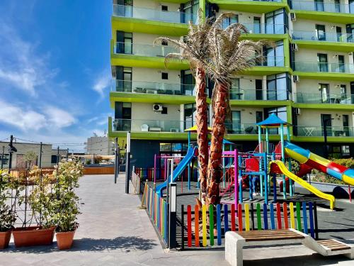 a playground in front of a apartment building at Summerland apartments and Alezzi apartments in Mamaia