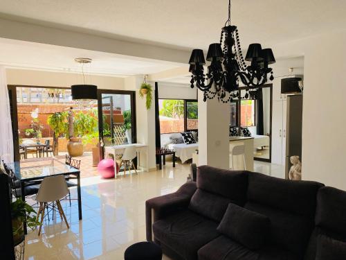 a living room with a couch and a table at Bungalow Paraiso in Callao Salvaje