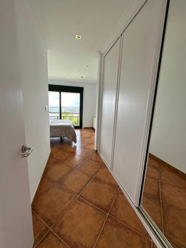 a hallway with glass doors and a tiled floor at Casa Suomi in Vigo