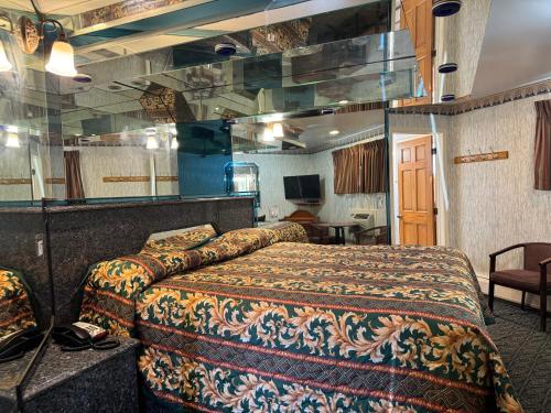 una camera d'albergo con letto e specchio di Royal Motel a Secaucus