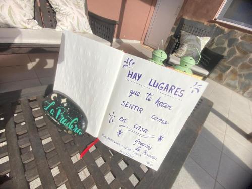 a sign on a bench with writing on it at La Pradera in Antigua