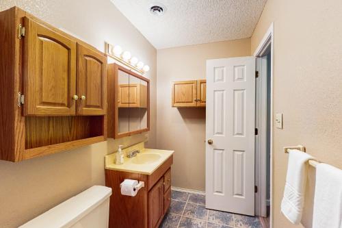 a bathroom with a sink and a toilet and a tub at Take a Break in Kingston