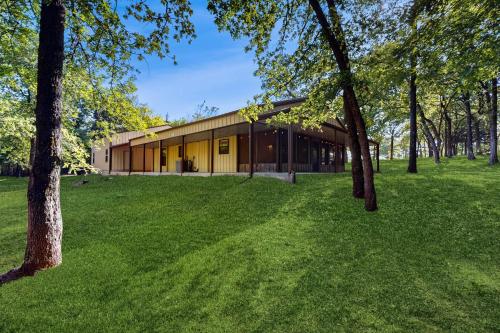 a building in a park with trees in the foreground at Take a Break in Kingston