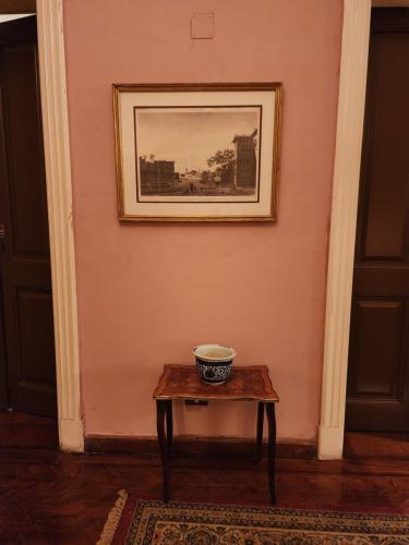 a table in a room with a picture on the wall at 10 Downtown in Cairo