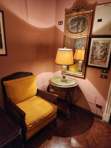 a chair and a table with a lamp in a room at 10 Downtown in Cairo