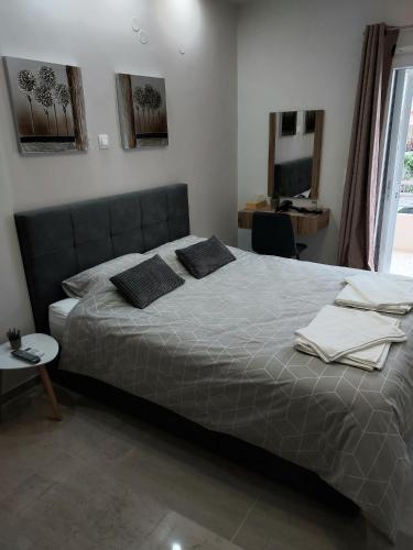 a bedroom with a bed with two pillows on it at Elena's Place, free parking!!! in Perea