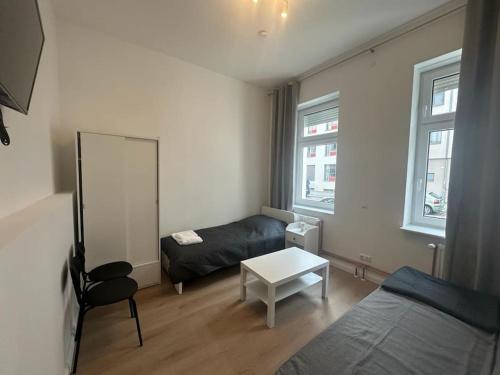 a small living room with a couch and a mirror at 2-Rooms apartment in Berlin in Berlin