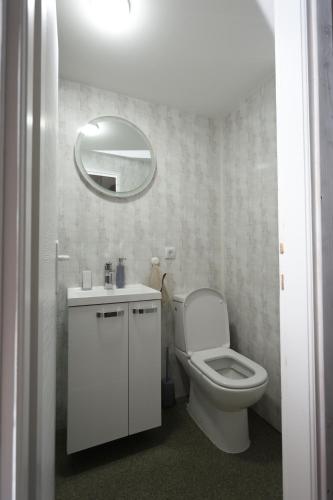 a white bathroom with a toilet and a mirror at Cherry Glamping Vranic in Vranić