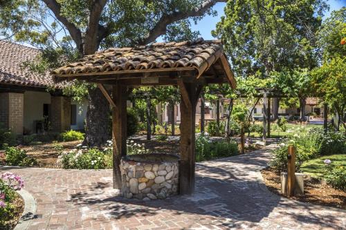 a wooden structure with a trash can in a park at Inn at San Luis Obispo in San Luis Obispo