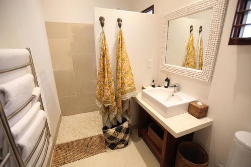 a bathroom with a sink and a mirror at Villa 25 in Port Vila