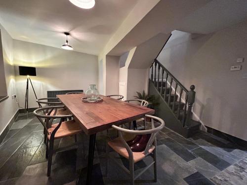 a dining room with a wooden table and chairs at The Round House in Strangford