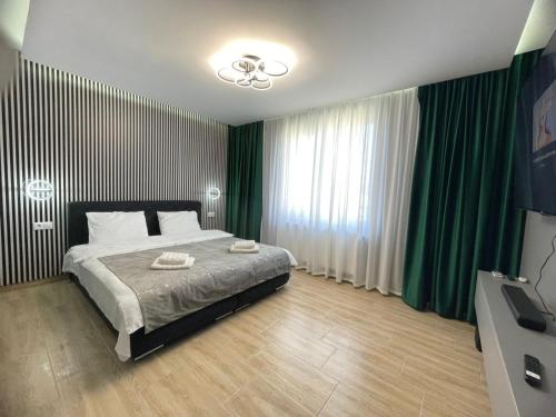a bedroom with a large bed with green curtains at The Nook in Sibiu