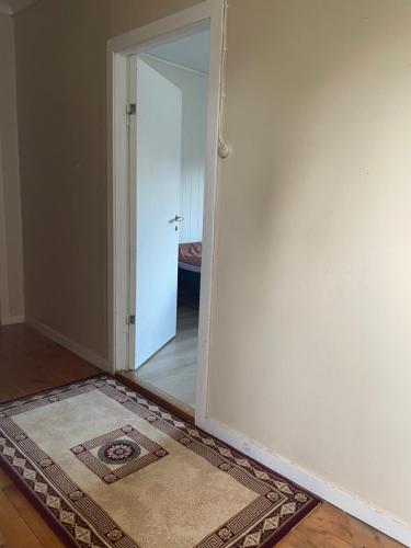 an empty room with an open door and a rug at Krokenes in Sylte