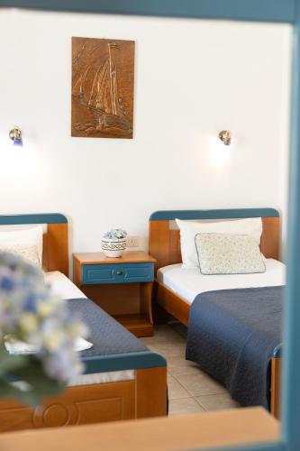 Postel nebo postele na pokoji v ubytování Villa Zeus INN