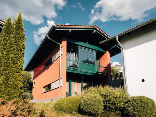 a building with a balcony on the side of it at Tranquil Holiday Home in Blossersberg with Terrace in Viechtach