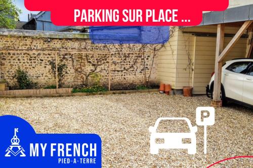 a gravel patio with a car parked in front of a building at Le Canyon Rouen Centre by MyFrenchPAT Terrasse & Parking in Rouen