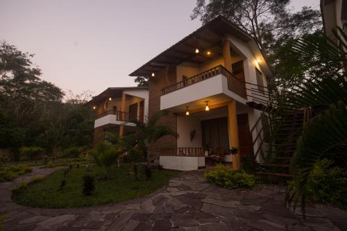 a house with a staircase in front of it at Villa Lu Amazon Ecolodge in Tarapoto