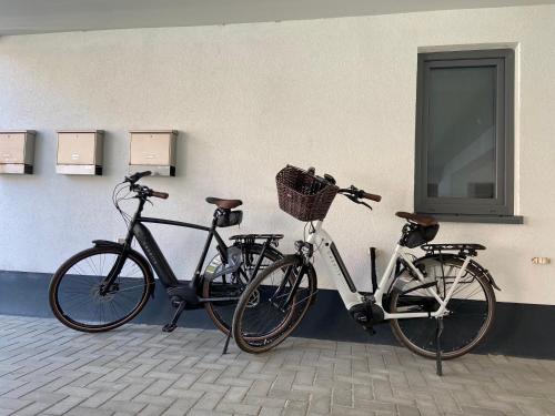 two bikes are parked next to a wall at Ferienwohnung "Delftbrise" Emden in Emden