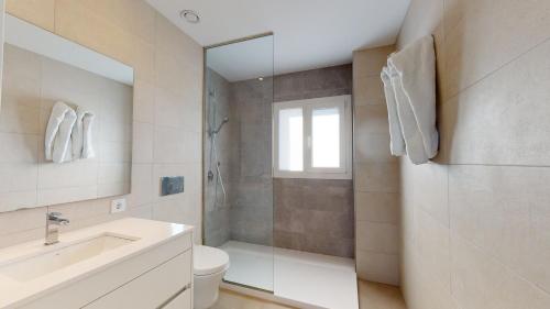 a bathroom with a shower and a toilet and a sink at Souvenir by ON Travel in Oliva