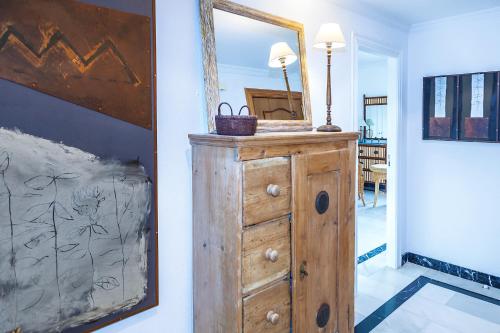 a mirror on top of a wooden dresser in a room at Mar-Beach front apartment in Jávea in Jávea