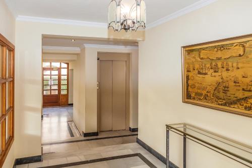 a hallway in a building with a painting on the wall at Mar-Beach front apartment in Jávea in Jávea
