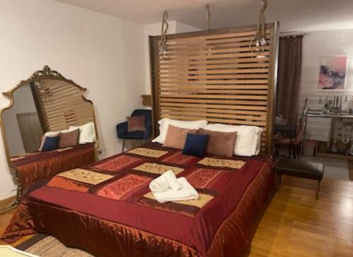 a bedroom with a large bed with two towels on it at B&B Villa Alma in San Cristoforo de Valli