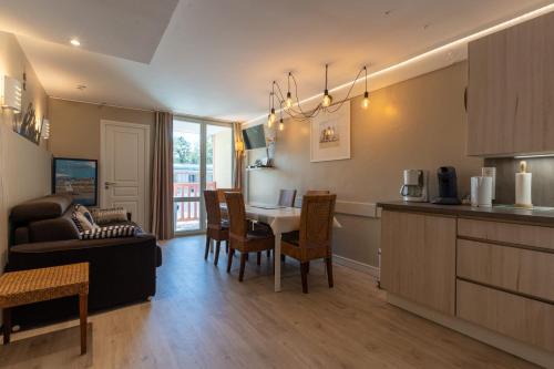 une cuisine et un salon avec une table et des chaises dans l'établissement Beautiful flat with swimming pool tennis court and private car parking 264, à Le Touquet-Paris-Plage