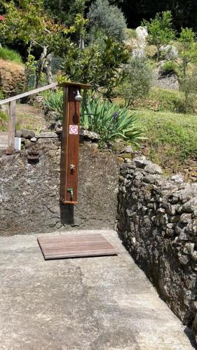 a wooden box sitting next to a stone wall at Casa Gio' in Pignone