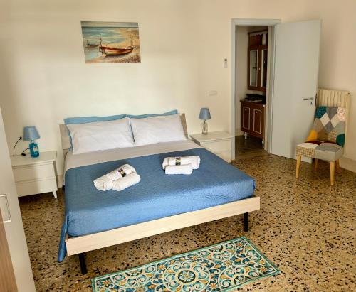 a bedroom with a bed with two towels on it at Casa Paolina in Uggiano la Chiesa