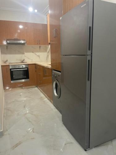 a kitchen with a stainless steel refrigerator at Manami Appartementen AlHoceima in Al Hoceïma