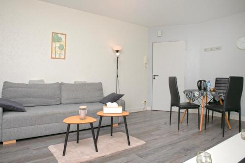 a living room with a couch and a table at Orphee Superbe T2 calme et paisible in Nantes