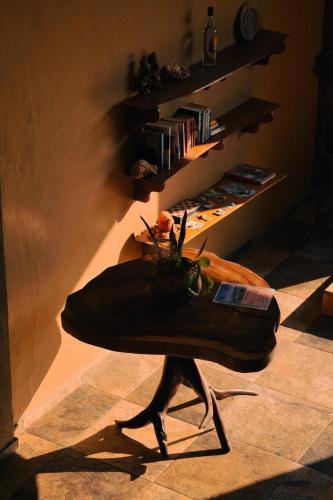a person walking in a room with a shoe on the floor at Beach Front Guesthouse in Puerto Escondido