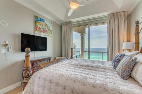 a bedroom with a large bed and a large window at Pensacola Beach Penthouse with View and Pool Access! in Pensacola Beach