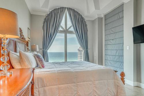 a bedroom with a bed and a large window at Pensacola Beach Penthouse with View and Pool Access! in Pensacola Beach