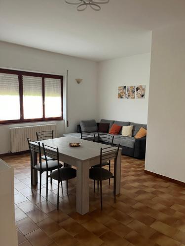 a living room with a table and chairs and a couch at Casa del Faggio Rosso in Bellagio
