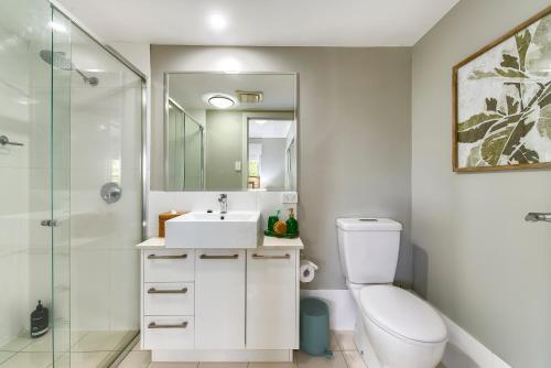a bathroom with a toilet and a sink and a shower at Experience this Stylish Brisbane Apartment in Brisbane