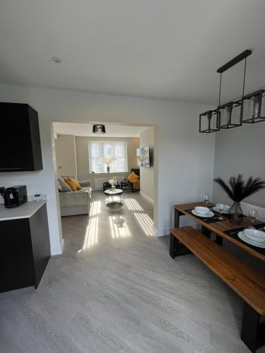 a living room with a couch and a table at The perfect place 3 Bedroom house with garden and parking in Barnsley