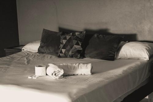 a black and white photo of a bed with two towels at Beach Front Guesthouse in Puerto Escondido