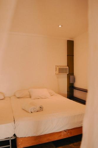 a bedroom with two beds with towels on them at Beach Front Guesthouse in Puerto Escondido
