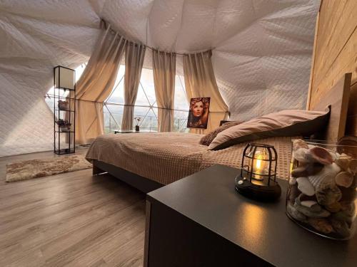 a bedroom with a bed with a mosquito net at Dilijan Glamping in Dilijan