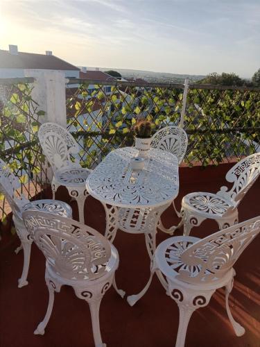 a table and chairs sitting on a balcony at Alojamento Local Largo da Igreja in Santiago do Cacém