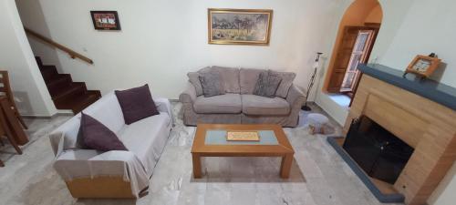 a living room with a couch and a coffee table at Dafnon Stone House in Leonidion