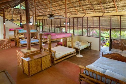 a room with several bunk beds in a house at Finca Popoyo in Popoyo
