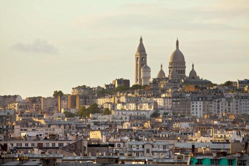 a city skyline with buildings and a clock tower at voco Paris - Porte de Clichy by IHG in Clichy