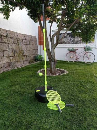 a yellow object with a tennis racket on the grass at Hakuna Matata in Cano