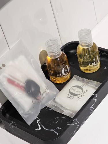 two bottles of essential oils on a black tray at BLACK BOX CINEMA appartement avec balnéo in Épinal